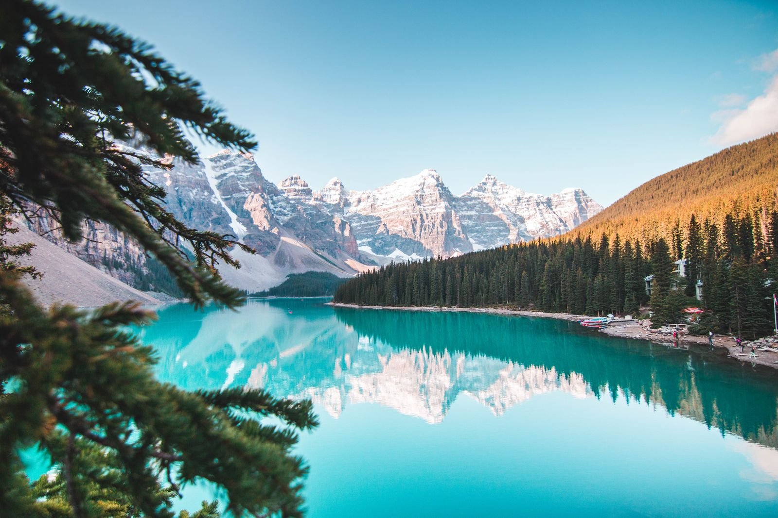 Turquoise alpine lake beneath snow-capped Colorado Rocky Mountain peaks